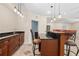 Basement bar area featuring granite countertops, wood accents, and pendant lighting at 150 Northshore Xing, Dallas, GA 30157