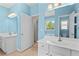 Light blue bathroom features dual vanity sinks, a window, and an ensuite at 150 Northshore Xing, Dallas, GA 30157