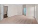 Large, carpeted bedroom featuring an ensuite bathroom and natural light at 150 Northshore Xing, Dallas, GA 30157