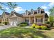 Charming two-story home featuring dormer windows, a covered porch, and well-maintained landscaping at 150 Northshore Xing, Dallas, GA 30157