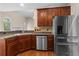 Modern kitchen with stainless steel appliances, dark wood cabinets, and granite countertops at 150 Northshore Xing, Dallas, GA 30157