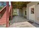 Covered patio with concrete flooring and access to stairs and a door, perfect for outdoor relaxation at 150 Northshore Xing, Dallas, GA 30157