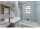 Tiled bathroom featuring a shower-tub combination and a decorative vanity with natural light at 20 Cheryl Ter, Covington, GA 30016