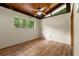 Sunlit bedroom features a ceiling fan, a view to the exterior, and sleek wood-look flooring at 20 Cheryl Ter, Covington, GA 30016