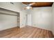 A light-filled bedroom featuring a closet with shelving and wood floors and accents at 20 Cheryl Ter, Covington, GA 30016