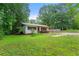 Exterior view of a single-story house with a covered porch and a spacious grassy front yard at 20 Cheryl Ter, Covington, GA 30016