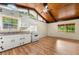 Well-lit kitchen featuring white cabinets, an appliance set, wood ceiling, and an adjacent eating area at 20 Cheryl Ter, Covington, GA 30016