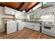 Kitchen area with white appliances, lots of cabinet space and wood flooring at 20 Cheryl Ter, Covington, GA 30016