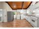 Kitchen features ample counter space, white appliances, and wood flooring at 20 Cheryl Ter, Covington, GA 30016