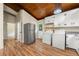 Efficient laundry area with wood ceiling, a stainless fridge, a washer, and a dryer in a well-lit space at 20 Cheryl Ter, Covington, GA 30016