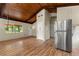 A living room with wood floors, a stainless refrigerator, a window, and a door to the exterior at 20 Cheryl Ter, Covington, GA 30016