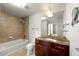 Bathroom featuring a granite vanity, bathtub with shower, and neutral tiling at 3300 Windy Ridge Se Pkwy # 809, Atlanta, GA 30339