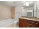 Neutral bathroom with walk-in shower, tub and dark wood vanity with marble countertop at 3300 Windy Ridge Se Pkwy # 809, Atlanta, GA 30339