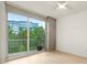 Bright bedroom with a large window, balcony, and modern ceiling fan at 3300 Windy Ridge Se Pkwy # 809, Atlanta, GA 30339