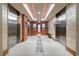 Hallway leading to elevators with modern lighting, tiled floors, and wood accents at 3300 Windy Ridge Se Pkwy # 809, Atlanta, GA 30339