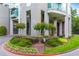 Lush landscaping surrounding the building's elegant entrance, featuring vibrant flowerbeds and manicured greenery at 3300 Windy Ridge Se Pkwy # 809, Atlanta, GA 30339