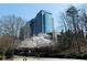 Modern high-rise building with sleek architecture surrounded by blooming trees at 3300 Windy Ridge Se Pkwy # 809, Atlanta, GA 30339