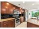 Modern kitchen features stainless steel appliances, dark wood cabinetry, granite countertops, and black tile backsplash at 3300 Windy Ridge Se Pkwy # 809, Atlanta, GA 30339