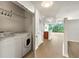 Bright condo laundry closet with full-size washer and dryer near living area at 3300 Windy Ridge Se Pkwy # 809, Atlanta, GA 30339