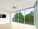 Bright living room featuring floor-to-ceiling windows with tree views, ceiling fan, and hardwood floors at 3300 Windy Ridge Se Pkwy # 809, Atlanta, GA 30339