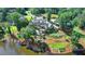 An aerial view shows a sprawling estate situated on a lake with manicured lawns and lush greenery at 4745 Cuyahoga Cv, Suwanee, GA 30024