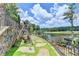 Serene backyard features a swing, lush landscaping, and scenic views of the lake and golf course at 4745 Cuyahoga Cv, Suwanee, GA 30024