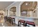Basement bar with seating facing the theater room at 4745 Cuyahoga Cv, Suwanee, GA 30024