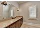 Elegant bathroom featuring granite countertop, vanity, and large mirror, creating a spacious feel at 4745 Cuyahoga Cv, Suwanee, GA 30024