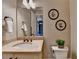Bathroom with a decorative sink, granite countertop, bronze faucet, wall art, and a toilet at 4745 Cuyahoga Cv, Suwanee, GA 30024