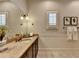 Well-lit bathroom featuring a granite countertop, bronze fixtures, and a decorative mirror with a vanity at 4745 Cuyahoga Cv, Suwanee, GA 30024