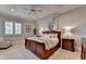 Bright bedroom with a wooden bed frame, neutral color scheme, and a window for natural light at 4745 Cuyahoga Cv, Suwanee, GA 30024