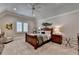 Charming bedroom features a wooden bed frame, neutral color palette, and ample natural light from the window at 4745 Cuyahoga Cv, Suwanee, GA 30024