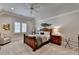 Charming bedroom features a wooden bed frame, neutral color palette, and ample natural light from the window at 4745 Cuyahoga Cv, Suwanee, GA 30024