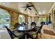 Beautiful covered patio features stone arches, dark wicker furniture, and a stone floor at 4745 Cuyahoga Cv, Suwanee, GA 30024