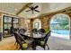 Covered patio features stone arches, dark wicker furniture, and a view of the pool at 4745 Cuyahoga Cv, Suwanee, GA 30024