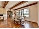 Bright dining area featuring a large window, designer lighting, and hardwood floors at 4745 Cuyahoga Cv, Suwanee, GA 30024