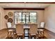 Elegant dining area featuring a wooden table, upholstered chairs, and decorative lighting at 4745 Cuyahoga Cv, Suwanee, GA 30024