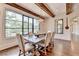 Bright dining area featuring a large window, designer lighting, and hardwood floors at 4745 Cuyahoga Cv, Suwanee, GA 30024