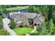 Stunning stone exterior of a luxury home with meticulously landscaped grounds and a view of the golf course at 4745 Cuyahoga Cv, Suwanee, GA 30024
