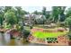 Stately stone home with manicured lawn, tiered landscaping, and lake view at 4745 Cuyahoga Cv, Suwanee, GA 30024