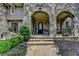 Charming stone-arched entrance with a beautifully designed front door, offering a warm welcome at 4745 Cuyahoga Cv, Suwanee, GA 30024
