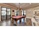 Entertaining game room with a billiards table and views to an outdoor patio, ideal for hosting gatherings at 4745 Cuyahoga Cv, Suwanee, GA 30024