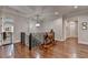 Upstairs hallway featuring a wooden rocking horse, iron railing, hardwood floors, and multiple doorways at 4745 Cuyahoga Cv, Suwanee, GA 30024