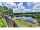 Serene lakeside view with a manicured lawn rolling down to the water and views of the golf course at 4745 Cuyahoga Cv, Suwanee, GA 30024