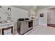 Bright laundry room features modern appliances, white cabinets, and ample counter space for folding and sorting laundry at 4745 Cuyahoga Cv, Suwanee, GA 30024