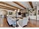 Spacious living room with fireplace, built-in bookshelves, hardwood floors and access to other rooms at 4745 Cuyahoga Cv, Suwanee, GA 30024