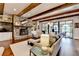 Inviting living room with stone fireplace, wood floors, and access to the outdoor living space at 4745 Cuyahoga Cv, Suwanee, GA 30024