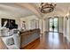 Open-concept living room with hardwood floors, large windows, and comfortable seating area at 4745 Cuyahoga Cv, Suwanee, GA 30024