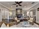 Living room with stone fireplace, recessed lighting, and two archways at 4745 Cuyahoga Cv, Suwanee, GA 30024