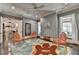 Inviting living room featuring beautiful leaf rug, neutral paint, and bright natural light at 4745 Cuyahoga Cv, Suwanee, GA 30024